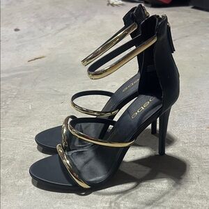 Bebe Elegant Black and Gold Heels